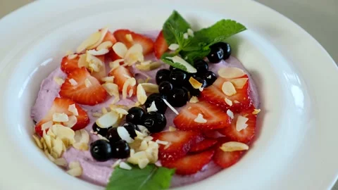 Delicious and quick breakfast with different summer berries and healthy cottage  Stock Footage 239925597
