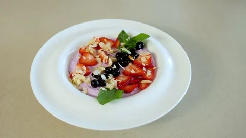 Delicious and quick breakfast with different summer berries and healthy cottage  Stock Footage 239925602