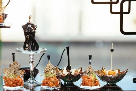 With a delicious appetizer, a buffet table with appetizers and a set of canap Stock Photos