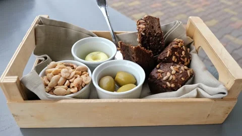 Delicious appetizers in restaurant, a snack, bread, olives, peanuts, butter Stock Footage 160117951