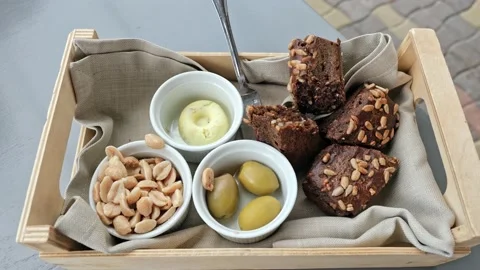 Delicious appetizers in restaurant, a snack, bread, olives, peanuts, butter Stock Footage 160118168
