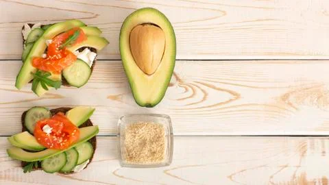 Delicious appetizing bars with fish, avocado, cream cheese and sesame seeds on a Stock Photos