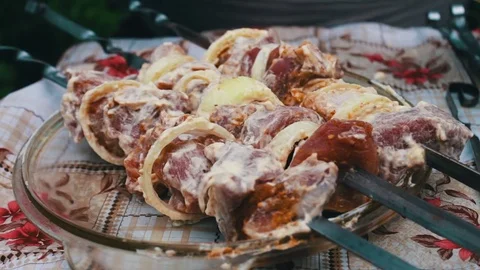 Delicious appetizing pieces of a fresh meat strung on skewers ready for barbecue Stock Footage
