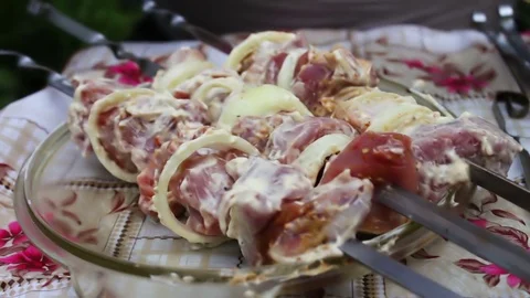 Delicious appetizing pieces of a fresh meat strung on skewers ready for barbecue Stock Footage