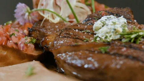 Delicious appetizing pork steak cooked on a grill close-up with cheese and bread Stock Footage 90495508