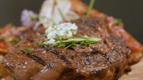 Delicious appetizing pork steak cooked on a grill close-up with cheese and bread Stock Footage 90495516