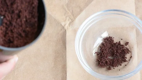 Delicious aromatic roasted cocoa beans are ground in a coffee grinder at home Video stock 94251757