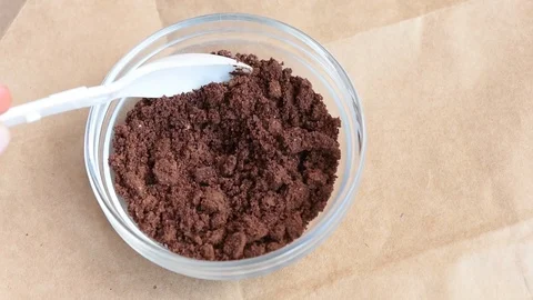 Delicious aromatic roasted cocoa beans are ground in a coffee grinder at home Stock Footage 94251769