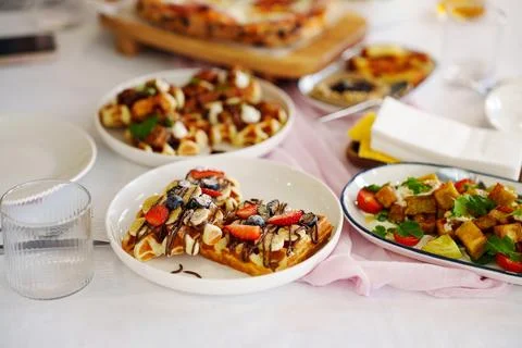 Delicious array of desserts and savory dishes on a table Stock Photos