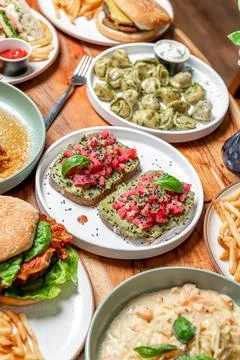 Delicious array of dishes on wooden table. A variety of dishes are spread a.. Foto stock