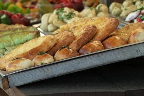 Delicious array of freshly baked breads at a bustling market Stock Photos