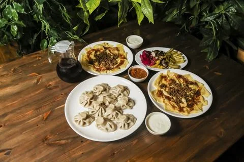 Delicious array of traditional dishes served on a wooden table Stock Photos