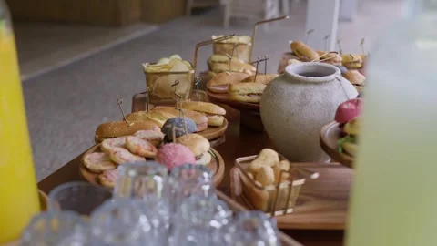 Delicious Assortment of Appetizers and Refreshing Drinks on Table Stock Footage 339011894
