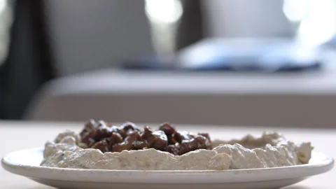 Delicious authentic hummus with meat being prepared in a restaurant 動画素材 345363098