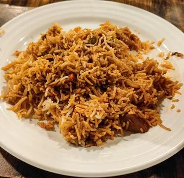 Delicious Authentic Hyderabadi Vegetable Biryani on White Plate, Spicy Indi.. Foto stock