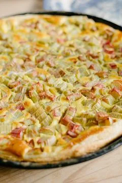 Delicious baked pie on flat baking pan placed on surface in daylight Stock Photos