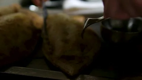 Delicious baked white fish wrapped in golden pastry crust being cut open with Stock Footage 318620612