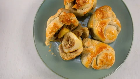Delicious baked wrapped in dough pears with nuts filling on plate on kitchen. Video stock 313047896