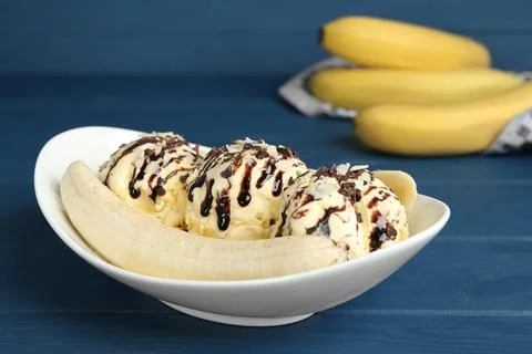 Delicious banana split ice cream on blue wooden table Stock Photos