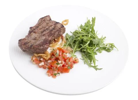 Delicious beef steak with arugula. Stock Photos