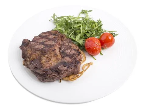 Delicious beef steak with arugula. Stock Photos