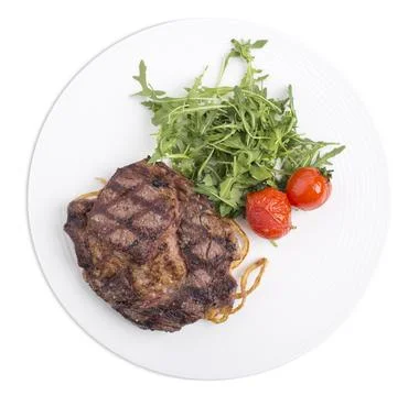 Delicious beef steak with arugula. Stock Photos