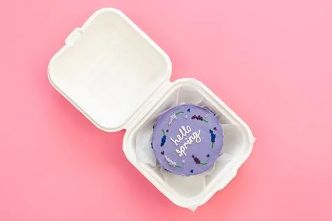Delicious bento cake Hello spring on a pink background, flat lay. Stock Photos