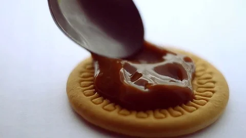 Delicious biscuits covered with milk. A large-scale correction with a spoon Stock Footage 73591735