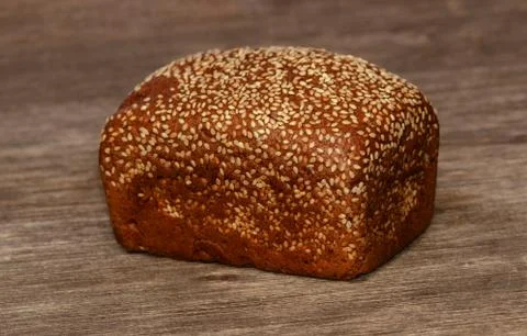 Delicious black bread on old tree background Stock Photos