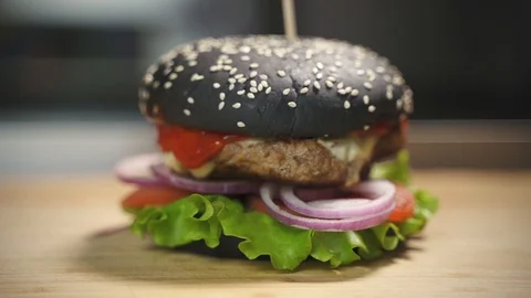 Delicious black burger Stock Footage 129685443