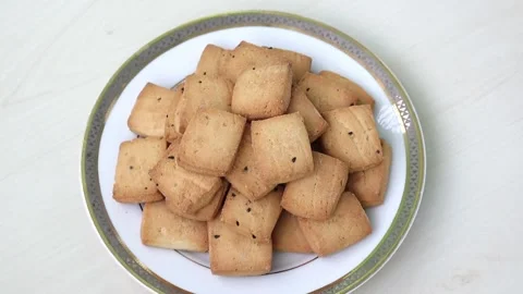 Delicious black cumin biscuits on a white plate with wooden background. Stock Footage 317867690