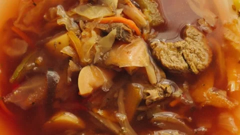 Delicious borscht soup with cabbage, potatoes, carrots, and beets. Just made in Stock Footage 330195190