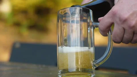 Delicious bottle of beer flows into a classic German beer glass 스톡 동영상 163468440