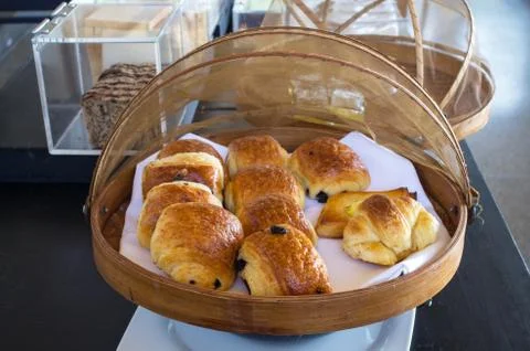 Delicious bread in basket on table for breakfast Stock Photos