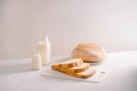Delicious bread on cutting board on table Stock Photos