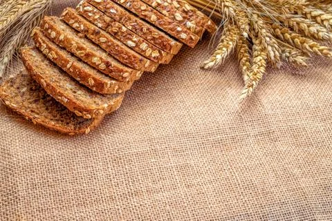 Delicious bread. Fresh loaf of rustic traditional bread with wheat grain ear or Stock Photos