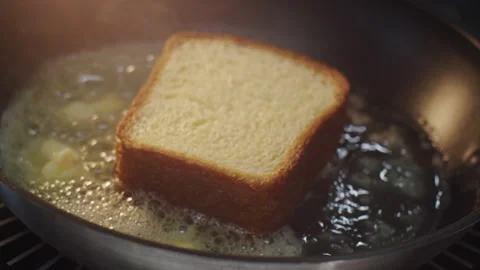 Delicious bread toast is fried with a lot of butter with steam in slow motion 스톡 동영상 150667640