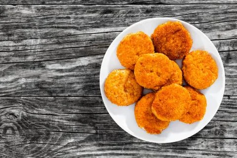 Delicious breaded meat cutlets on white plate Stock Photos