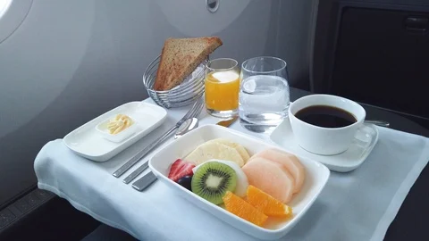 Delicious breakfast with fruit served on board of business class airplane. Stock Footage 117073476