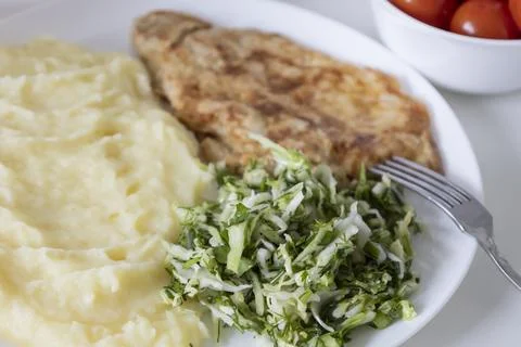 A delicious breakfast or lunch with mashed potatoes, chop with salad - gree.. Stock Photos