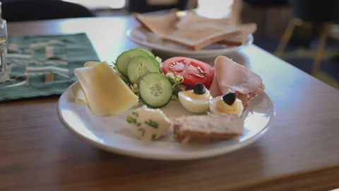 Delicious breakfast platter with sliced ham, cheese, fresh cucumbers and toast. Stock Footage 340342308