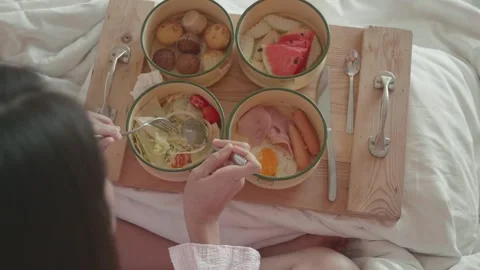 Delicious Breakfast Spread Enjoyed in Bed Stock Footage 327577792