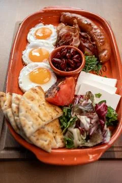 Delicious breakfast spread featuring eggs, sausage, and fresh vegetables Stock Photos