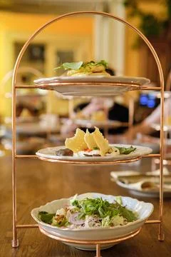 Delicious breakfast on three tier serving dish. Salad of vegetables and chick Stock Photos