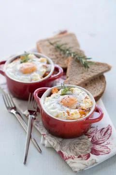 A delicious breakfast time, one serving of red pots of eggs Stock Photos