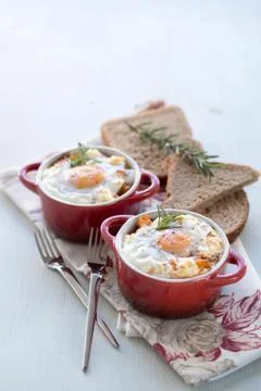 A delicious breakfast time, one serving of red pots of eggs Stock Photos