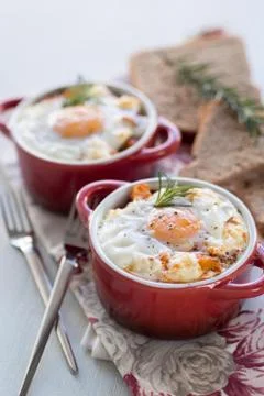 A delicious breakfast time, one serving of red pots of eggs Stock Photos