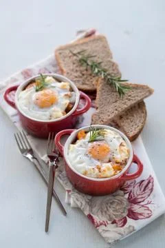 A delicious breakfast time, one serving of red pots of eggs Stock Photos