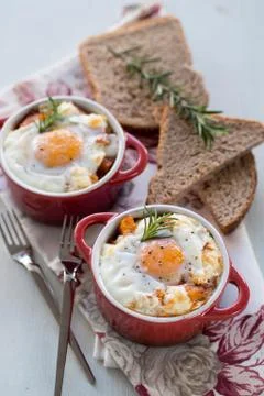 A delicious breakfast time, one serving of red pots of eggs Stock Photos