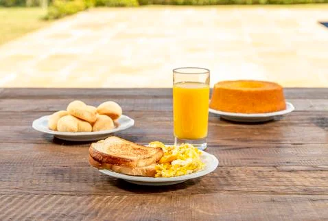 Delicious breakfast, with toast and eggs, with a glass of orange juice, papay Stock Photos